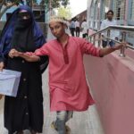 প্রতিবন্ধী শিক্ষার্থী ওহিদুল ইসলাম বাম হাতে এসএসসি পরীক্ষা দিচ্ছে মোরেলগঞ্জ কেন্দ্রে